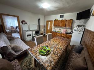 a living room with a table and a kitchen at Kuća za odmor Karaklić in Donje Karaklije +29 photos