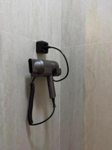 a phone hanging on a wall in a bathroom at Luxoria hotel in Astana