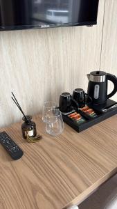 a table with a tray with a coffee pot and glasses at Luxoria hotel in Astana +9 photos