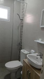 a bathroom with a toilet and a sink at Acacia Nest in Tangier