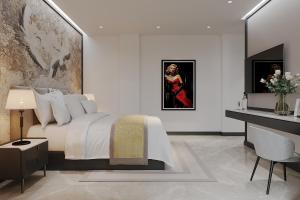 a bedroom with a bed and a table and a painting at Anvi Boutique Hotel Hanoi in Hanoi +31 photos