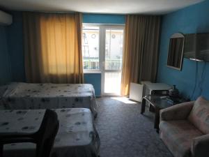 a hotel room with two beds and a couch at Hostel Papagal in Varna City