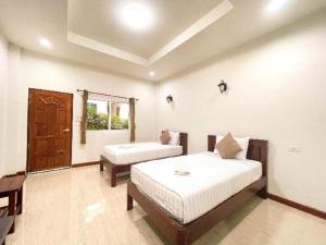 a bedroom with two beds and a window at janwareeresort in Sangkhla Buri +23 photos