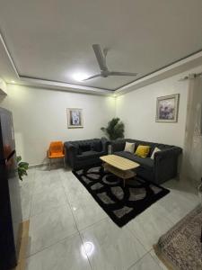 a living room with a couch and a table at Mombasa 1 Bedroom Apartment in Mombasa