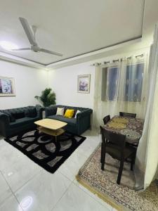 a living room with a couch and a table at Mombasa 1 Bedroom Apartment in Mombasa +2 photos