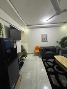 a living room with a couch and a table at Mombasa 1 Bedroom Apartment in Mombasa