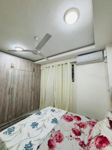a bedroom with a bed and a ceiling fan at Mombasa 1 Bedroom Apartment in Mombasa