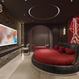a bedroom with a red bed and a tv at Anvi Boutique Hotel Hanoi in Hanoi