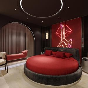 a bedroom with a red bed and a chair at Anvi Boutique Hotel Hanoi in Hanoi