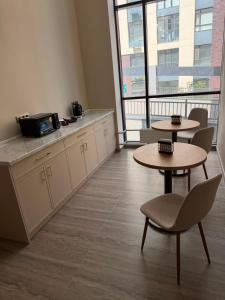 a room with two tables and a counter with two tables at Luxoria hotel in Astana