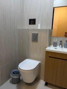 a bathroom with a toilet and a sink at Luxoria hotel in Astana