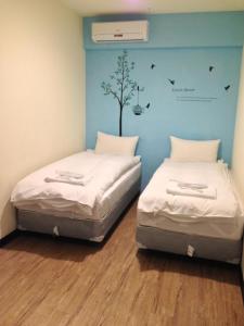 Galaxy Mini Inn tesisinde bir odada yatak veya yataklar