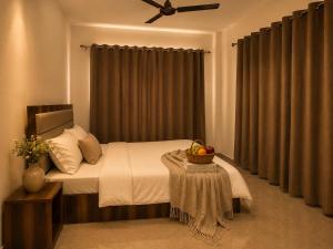 a bedroom with a bed with a ceiling fan at The Sanctuary in McLeod Ganj