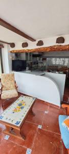 a living room with a bench and a table at Casa la Solana 1915 in Lucena del Cid