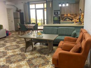 a living room with two couches and a table at Style Home Buzovna in Baku