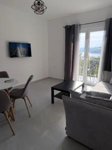 a living room with a couch and a table at Quattro Rocce Apartments Zelen in Sutomore