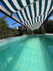a swimming pool with a roof over the water at Klára House - Covasna in Covasna