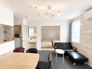 a living room with a couch and a table at 優富良野 in Furano