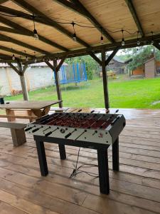 a ping pong table sitting on top of a patio at Chatka Oli in Zubacze