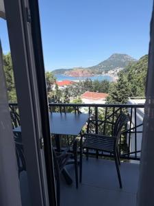 a balcony with a table and chairs and a view at Quattro Rocce Apartments Zelen in Sutomore