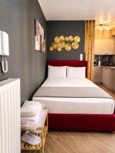 a bedroom with a large bed with a red headboard at GPX CLR - MicroLuxe Suite in Larisa