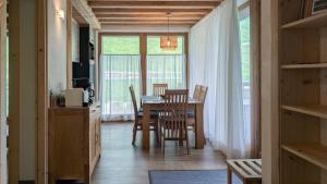 a kitchen and dining room with a table and chairs at Tilio Chalet in Livigno