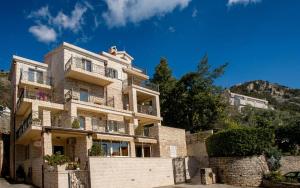 a house on the side of a mountain at Turkuaz Boutique Hotel in Sveti Stefan