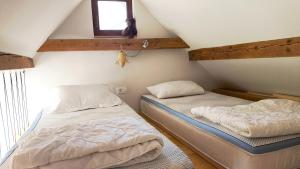 two twin beds in a room with a window at Fresh romance by the river in Bohinj