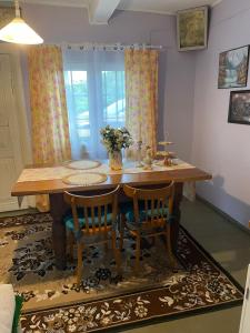 a dining room table with two chairs and a table at Chatka Oli in Zubacze +23 photos