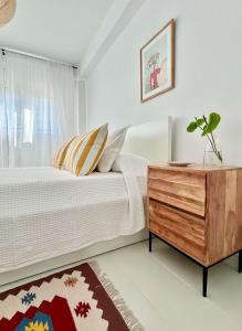 a bedroom with a bed and a dresser and a window at casArena 1 in Las Negras
