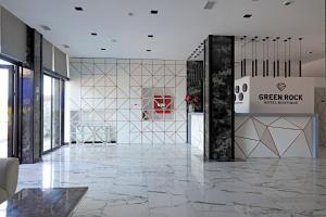 a lobby with a marble floor and a sign on a wall at Hotel Green Rock in Kvariat'i