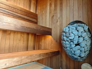 a sauna with a basket of rocks on the wall at Hótel Tindastóll in Sauðárkrókur +56 photos