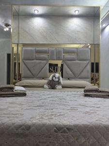 a teddy bear sitting on a bed in a room at B&B la marica in Adrano