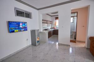 a living room with a refrigerator and a kitchen at Talia holiday home ,Malindi kenya -1 in Malindi