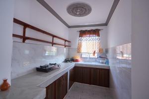 a kitchen with a sink and a window at Talia holiday home ,Malindi kenya -1 in Malindi +5 photos