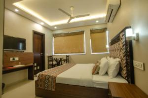 a hotel room with a bed and a television at Hotel Jullundur 18 in Chandīgarh