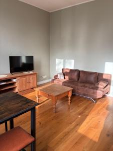 a living room with a couch and a coffee table at Gästehaus LeLo 6 in Solingen