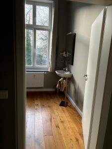 a bathroom with a sink and a window at Gästehaus LeLo 6 in Solingen