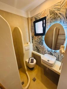 a small bathroom with a sink and a mirror at Hotel marmaras in Neos Marmaras +56 photos