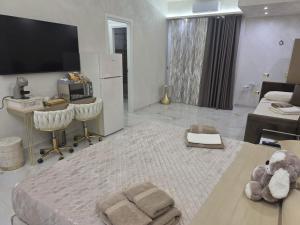 a white living room with a teddy bear sitting on a table at B&B la marica in Adrano