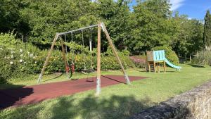 a swing set in a park with a blue bench at Agriturismo Podere La Casaccia in Poppi