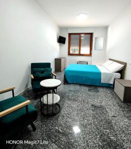 a bedroom with a bed and a table and a chair at Brezza Marina in Tortoreto Lido