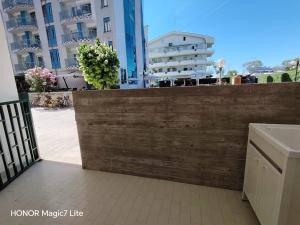 a wooden fence in front of some buildings at Brezza Marina in Tortoreto Lido