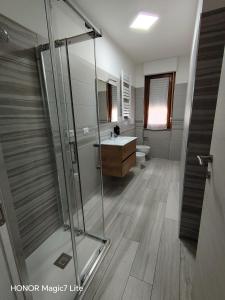 a bathroom with a shower and a sink and a toilet at Brezza Marina in Tortoreto Lido
