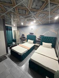 a room with two beds in a room at Karachi Family Guest House in Karachi