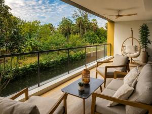a balcony with a view of the forest at Laguna Seaside 3 bed #84195 in Bang Tao Beach