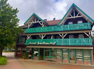 a building with green balconies on top of it at Hotel Berliner Hof in Braunlage