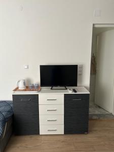 a tv sitting on top of a dresser in a room at Rooms Lepara in Konjic