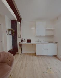 a white kitchen with a sink and a counter at Suite in Centro in Vasto