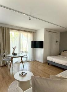 a living room with a bed and a table at Luxury Apartment Vorstetten Modern Zentral in Vörstetten